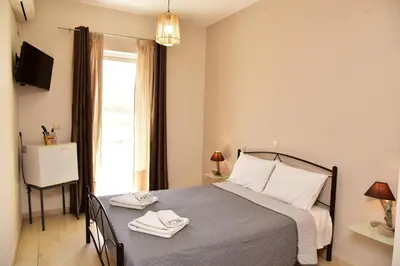 a bedroom with a bed with two towels on it at Rooms Kochilas Elafonisi in Elafonisi
