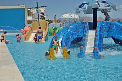 a group of people playing in a water park at Kastalia Village ,Saint Nikolas resort in Kolymvari