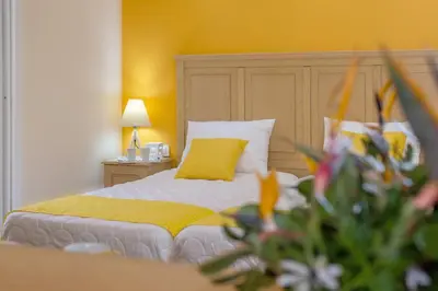 a bedroom with a bed with a yellow wall at Kastalia Village ,Saint Nikolas resort in Kolymvari