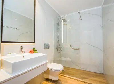 a bathroom with a white sink and a shower at Kastalia Village ,Saint Nikolas resort in Kolymvari