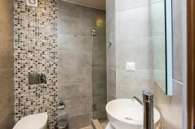 a bathroom with a toilet and a sink at Villa Aelia I Modern & Ideal for large groups in Galatás