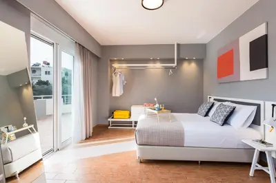 a bedroom with a white bed and a balcony at Villa Aelia I Modern & Ideal for large groups in Galatás