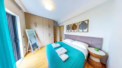 a bedroom with a large bed with a blue blanket at Villa Veggera Chania in Kondomari