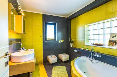 a bathroom with a tub and a toilet and a sink at Villa Veggera Chania in Kondomari