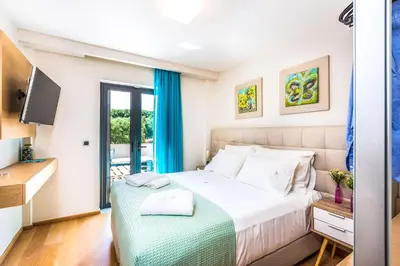 a bedroom with a bed and a desk and a television at Villa Veggera Chania in Kondomari