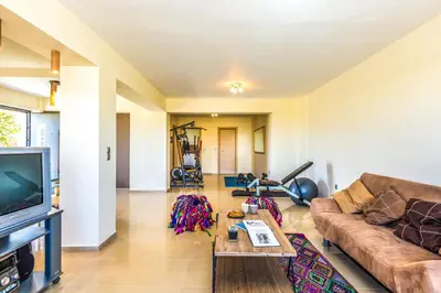 a living room with a couch and a tv at Villa Veggera Chania in Kondomari