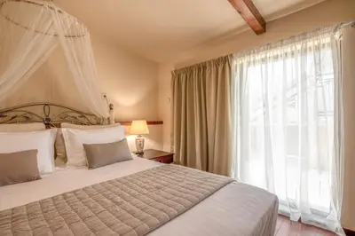 a bedroom with a large bed and a large window at Kalliopi's Maisonette in Chania Town