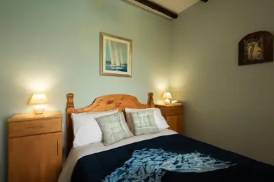 a bedroom with a bed with two lamps and a bedspread at Villa Georgia in Kalyves