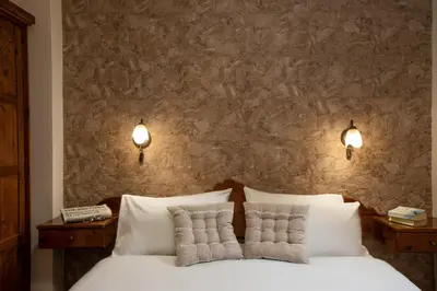 a bedroom with a white bed with two pillows at Villa Georgia in Kalyves