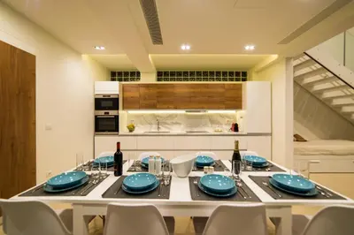 a dining room with a table and chairs and a kitchen at Villa L2/ Boutique Villa in Kato Daratso