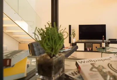 a living room with a vase with a plant on a table at Villa L2/ Boutique Villa in Kato Daratso