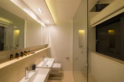 a bathroom with two sinks and a glass shower at Villa L2/ Boutique Villa in Kato Daratso