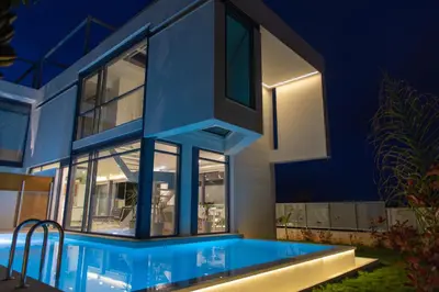 a house with a swimming pool at night at Villa L2/ Boutique Villa in Kato Daratso