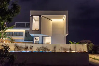 a house with lights on the side of it at night at Villa L2/ Boutique Villa in Kato Daratso