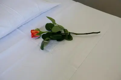 a flower in a vase on a white table at Suites Pandora in Chania Town