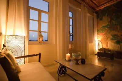 a living room with a table and a window at Suites Pandora in Chania Town