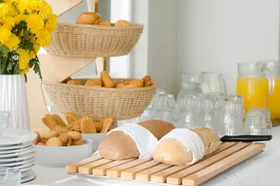 a table with two loaves of bread on a cutting board at Nautilus Bay Hotel in Kissamos