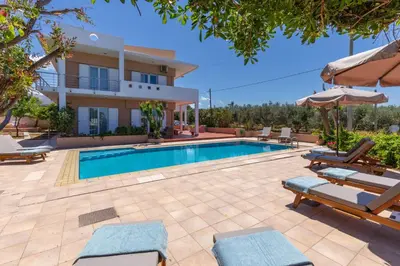 a villa with a swimming pool and a house at Villa Armonia Chania in Kato Galatas