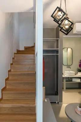 a staircase in a living room with a table at The48suites in Chania Town