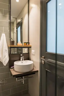 a bathroom with a white sink and a mirror at The48suites in Chania Town