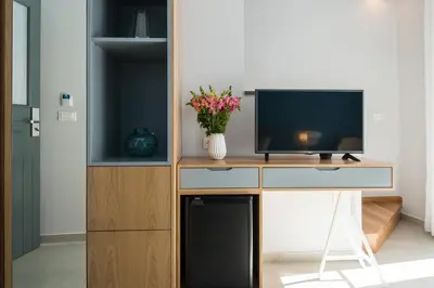 a living room with a tv and a desk with a television at The48suites in Chania Town