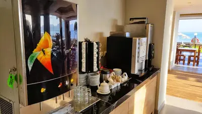 a kitchen with a counter with a microwave and a coffee maker at Sunny Bay Hotel in Kissamos