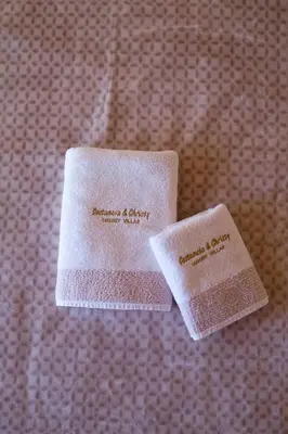 two white towels sitting on top of a bed at Villa Christy in Stalos