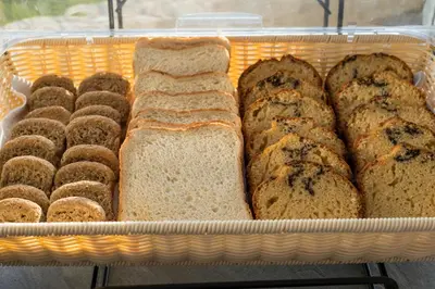 a basket filled with different types of bread and donuts at Hotel Caretta Beach in Gerani Chanion