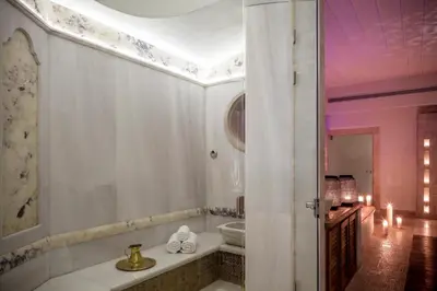 a white bathroom with a tub and a shower at Casa Delfino Hotel & Spa in Chania Town