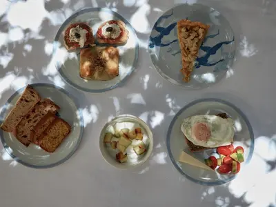 four plates of different types of food on a table at Casa Delfino Hotel & Spa in Chania Town