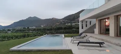 a house with a swimming pool with mountains in the background at Casa le Cicale in Falasarna