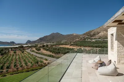 a patio with a view of a vineyard at Casa le Cicale in Falasarna