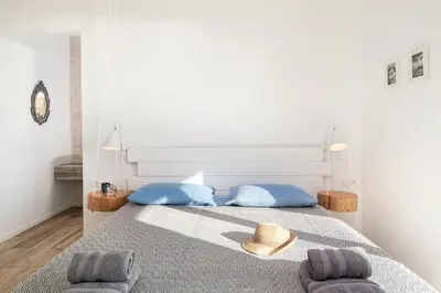 a bedroom with a bed with a hat and two pillows at Casa le Cicale in Falasarna