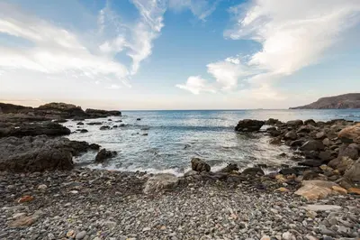 a rocky beach with the ocean in the background at Pericles Beach Villa in Kissamos