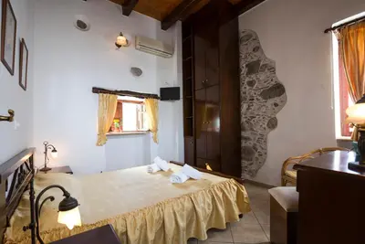 a room with a bed with towels on it at Pericles Beach Villa in Kissamos
