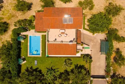 an overhead view of a house with a swimming pool at Villa Giannis in Áyios Andónios