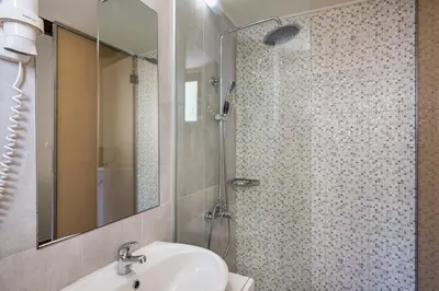 a bathroom with a sink and a shower at Magia Apartments in Chania Town