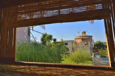 a window view of a building through a window at Anemomili Village in Kissamos