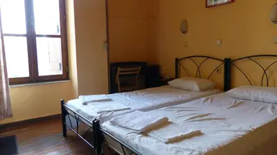two beds sitting next to each other in a room at Kydonia Rooms in Chania Town