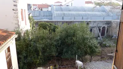 an outside view of a building with a bush at Kydonia Rooms in Chania Town