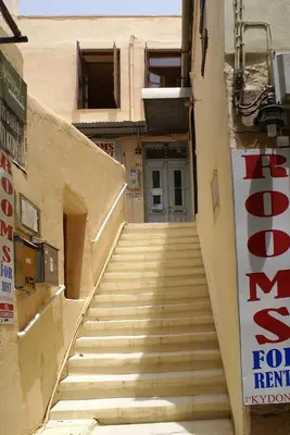 a staircase leading up to a building with a for rent sign at Kydonia Rooms in Chania Town
