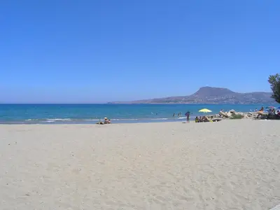 a group of people on a beach near the ocean at Villa Vangelis Stylos Crete in Khiliomoudhoú