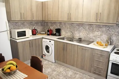 a kitchen with a sink and a washing machine at Gardens Downtown center Chania Elpida Villa in Chania Town