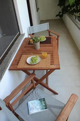 a wooden table with two plates of food on it at Gardens Downtown center Chania Elpida Villa in Chania Town