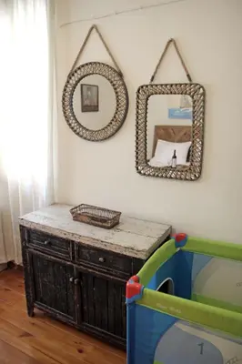 a room with a mirror and a wooden dresser at Gardens Downtown center Chania Elpida Villa in Chania Town