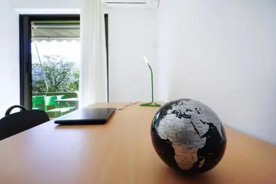 a globe sitting on top of a desk with a laptop at Sunhouse-CH in Chania Town