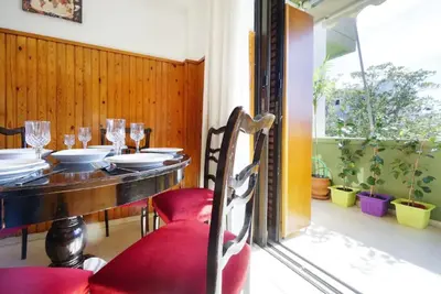 a dining room with a table and red chairs at Sunhouse-CH in Chania Town