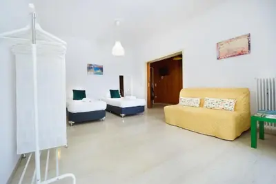 a living room with two beds and a couch at Sunhouse-CH in Chania Town