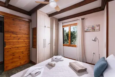 a bedroom with a bed with towels on it at Wooden Beach House in Gerani Chanion