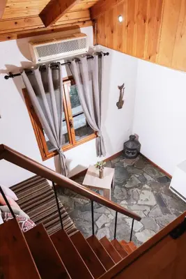 an attic room with a staircase and a window at Wooden Beach House in Gerani Chanion